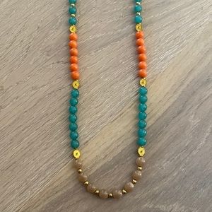 Long coral, blue, and tan beaded necklace.